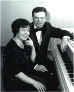 Antra and Normunds Viksne beside a grand piano